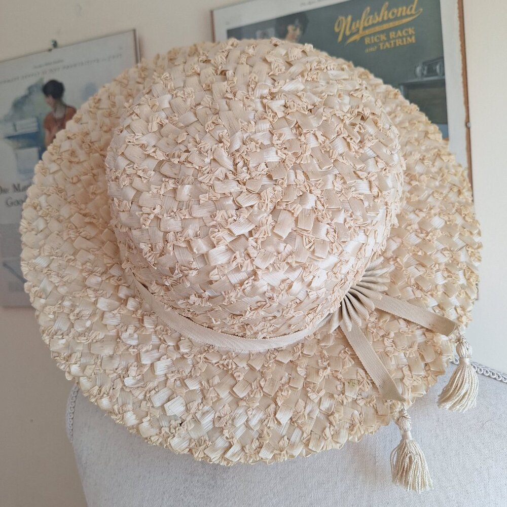 Vintage natural colored straw hat with natural colored ribbon & tassle accent.